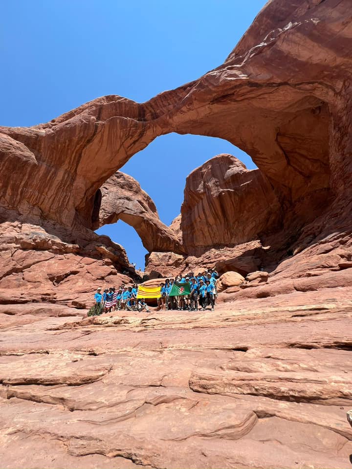 The troop with flags beneath Double Arch