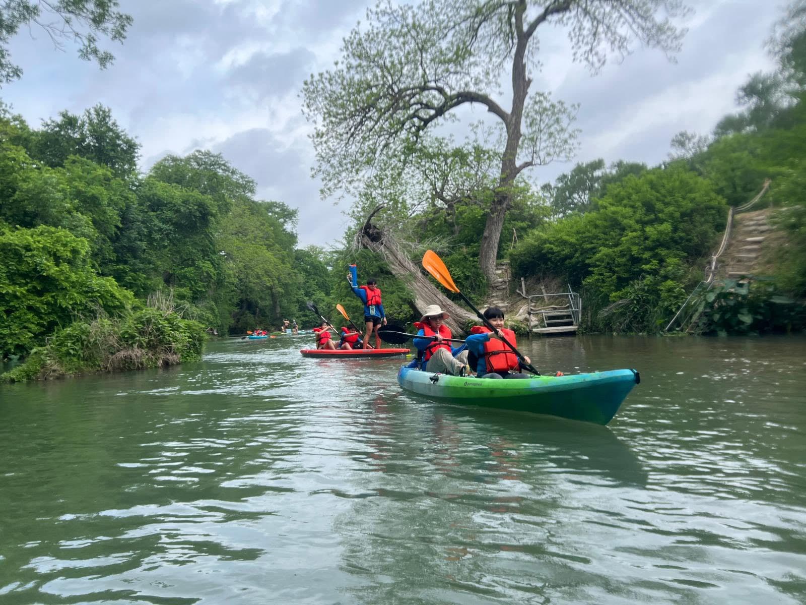 Kayaks on the river between canyon walls