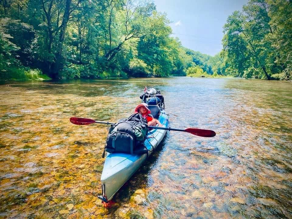 Scouts paddling kayaks down the river