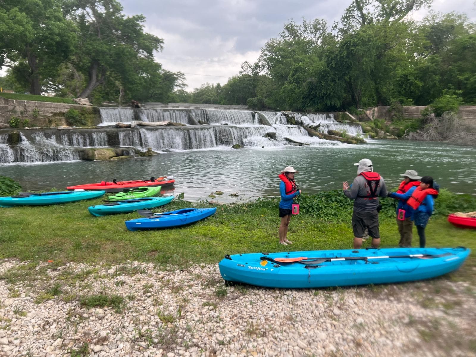 Scouts kayaking near a waterfall